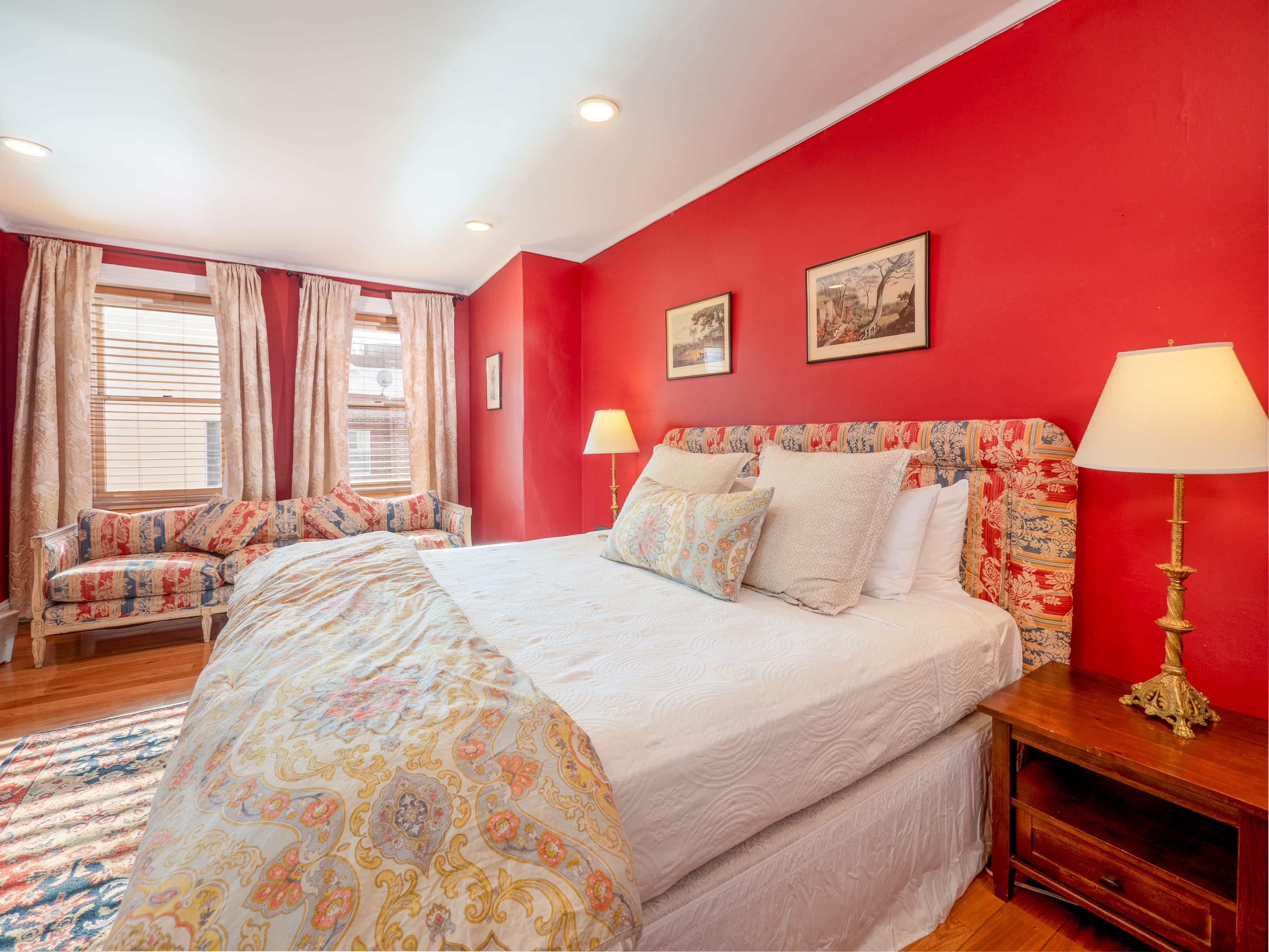 Closeup of the bed with nice natural lighting from the windows.