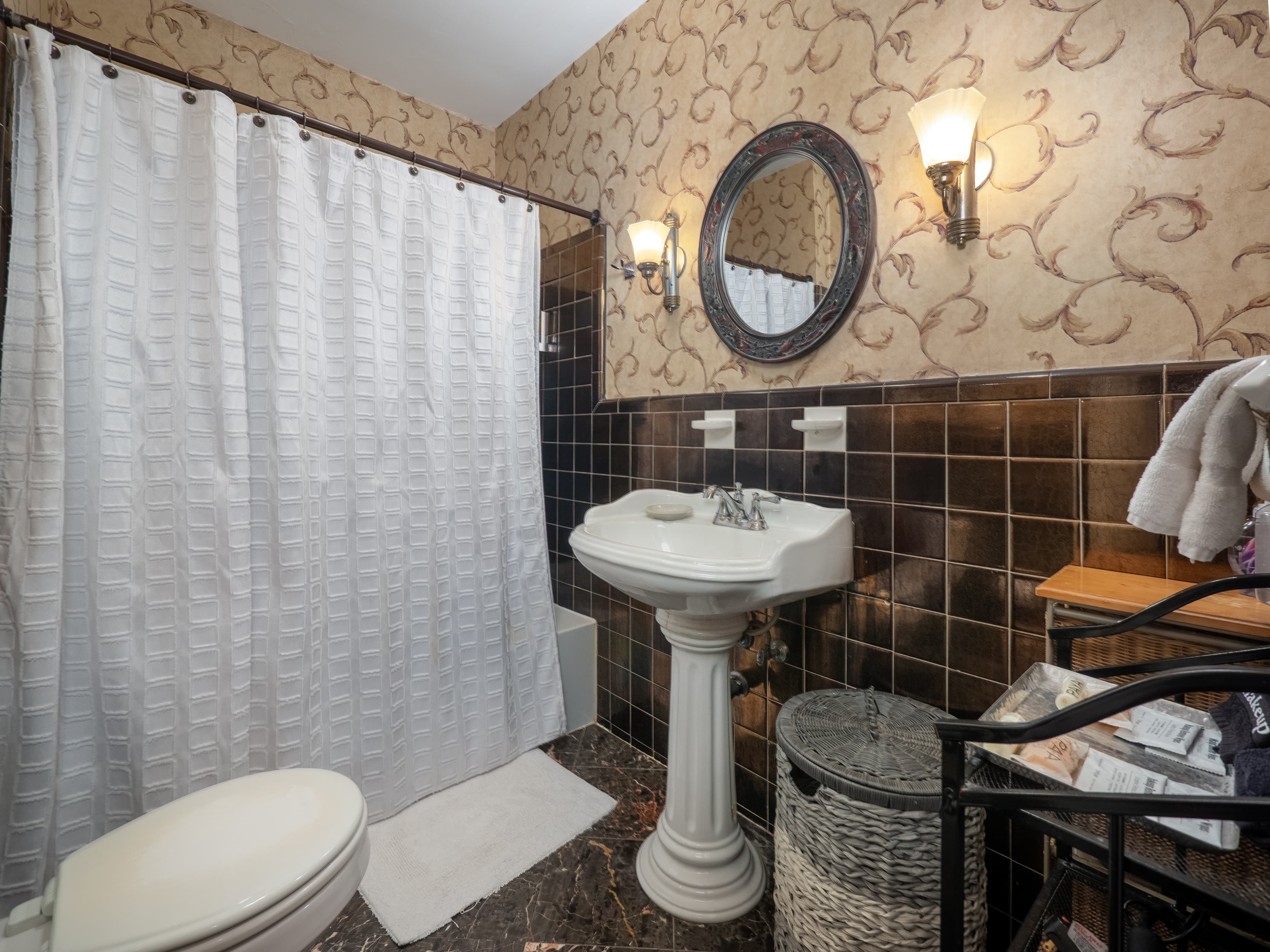 Full bathroom with half tile walls.