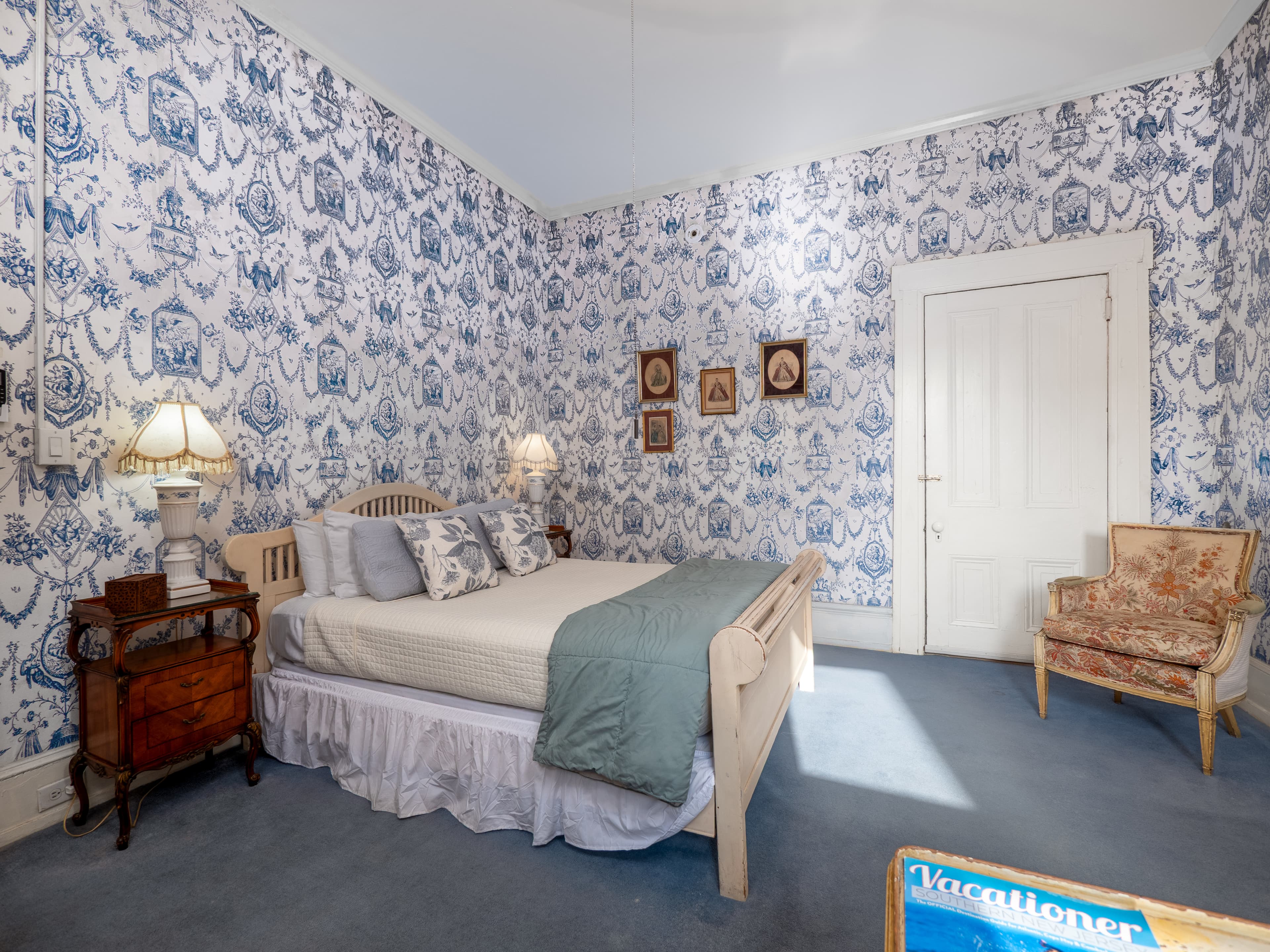 Alternative shot of the bedroom facing the bed, closet, and cushioned chair.