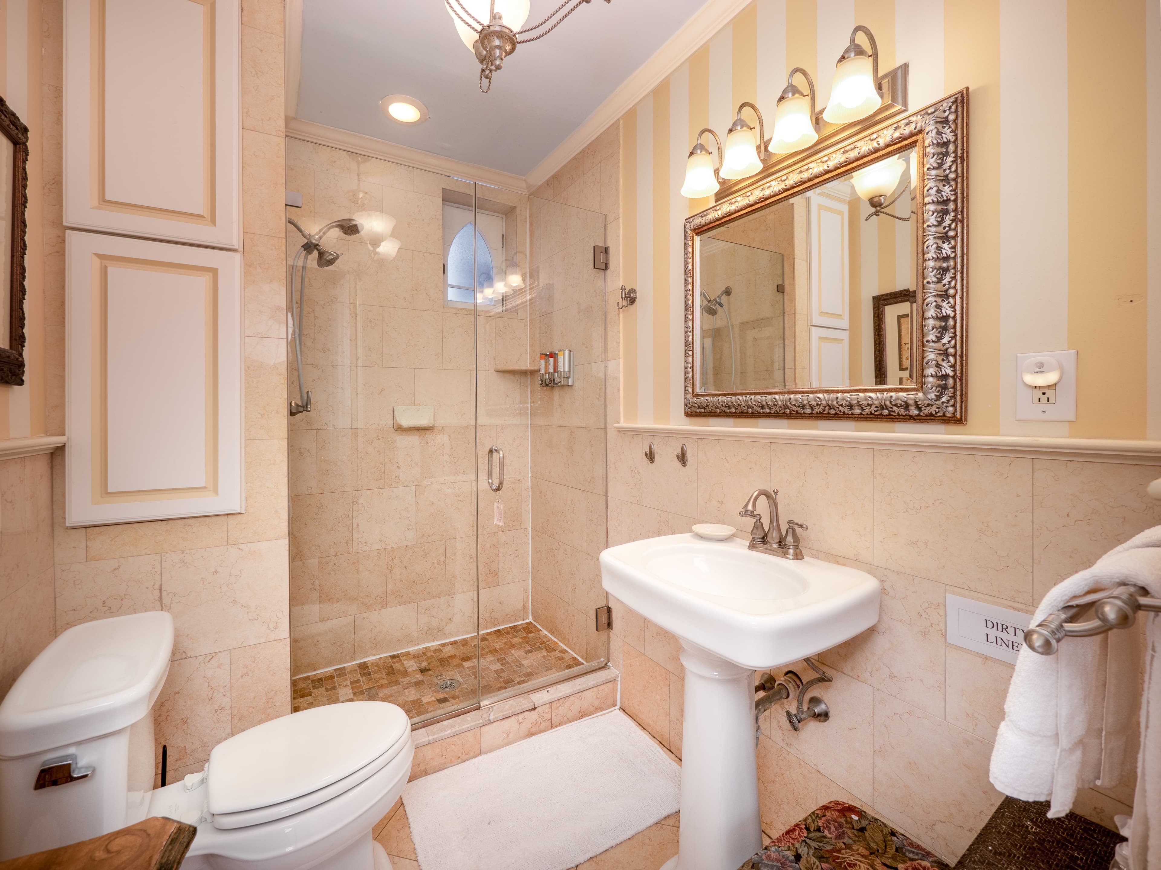 Full bathroom with glass door standing shower.