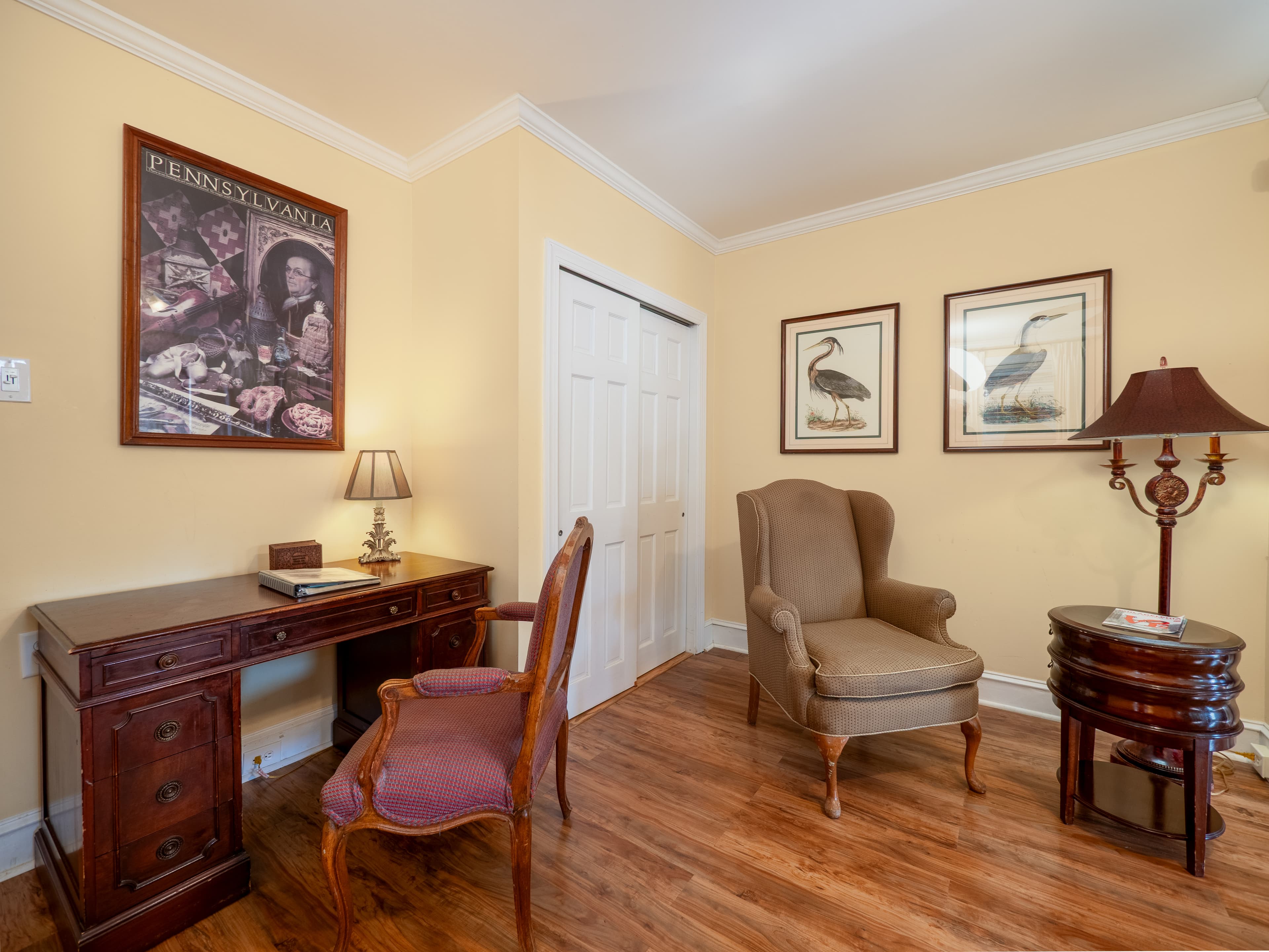 Cozy look at two armchairs and a desk next to the closet.