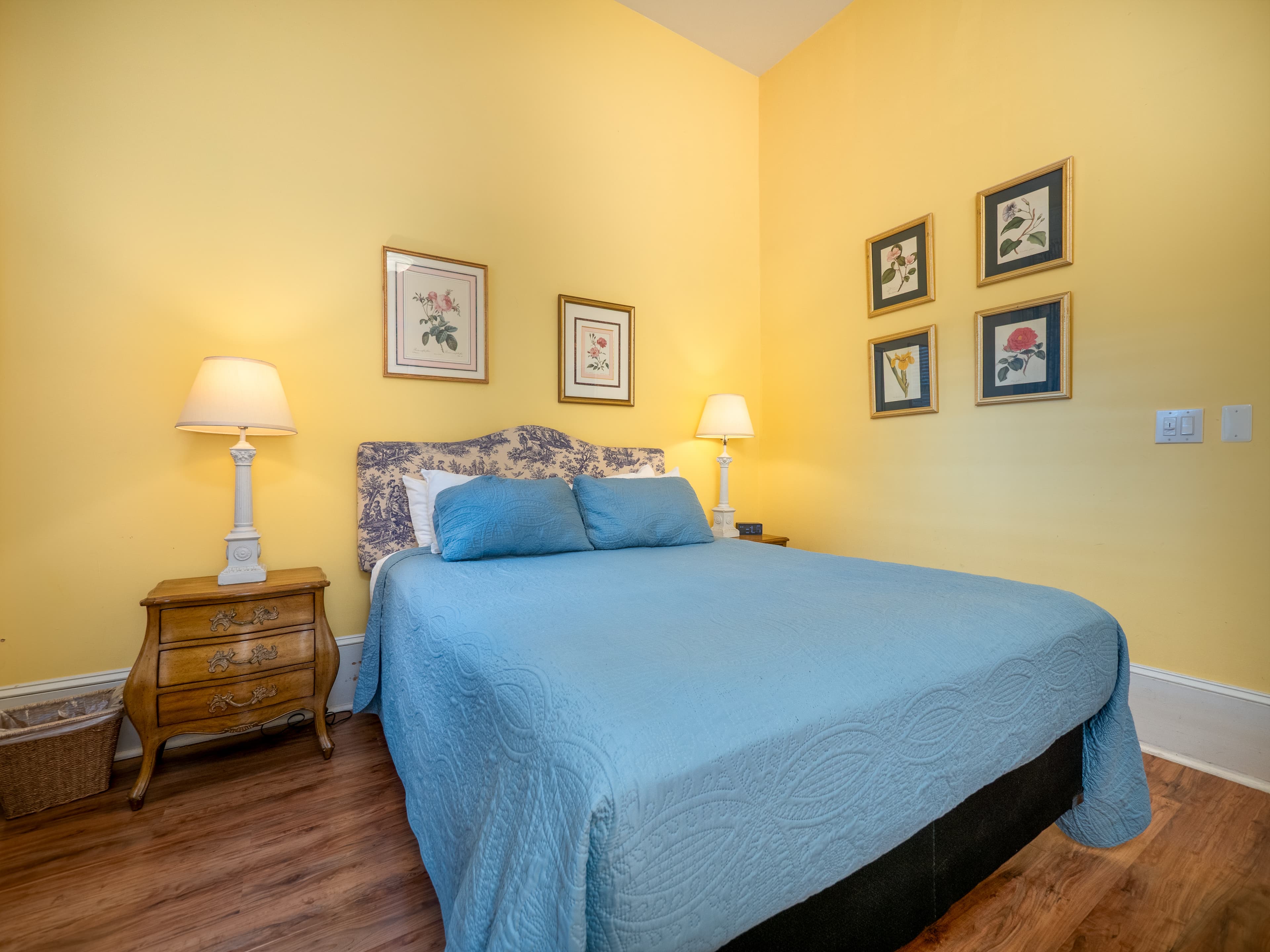 Close up of the queen bed and side tables with lamps on them.