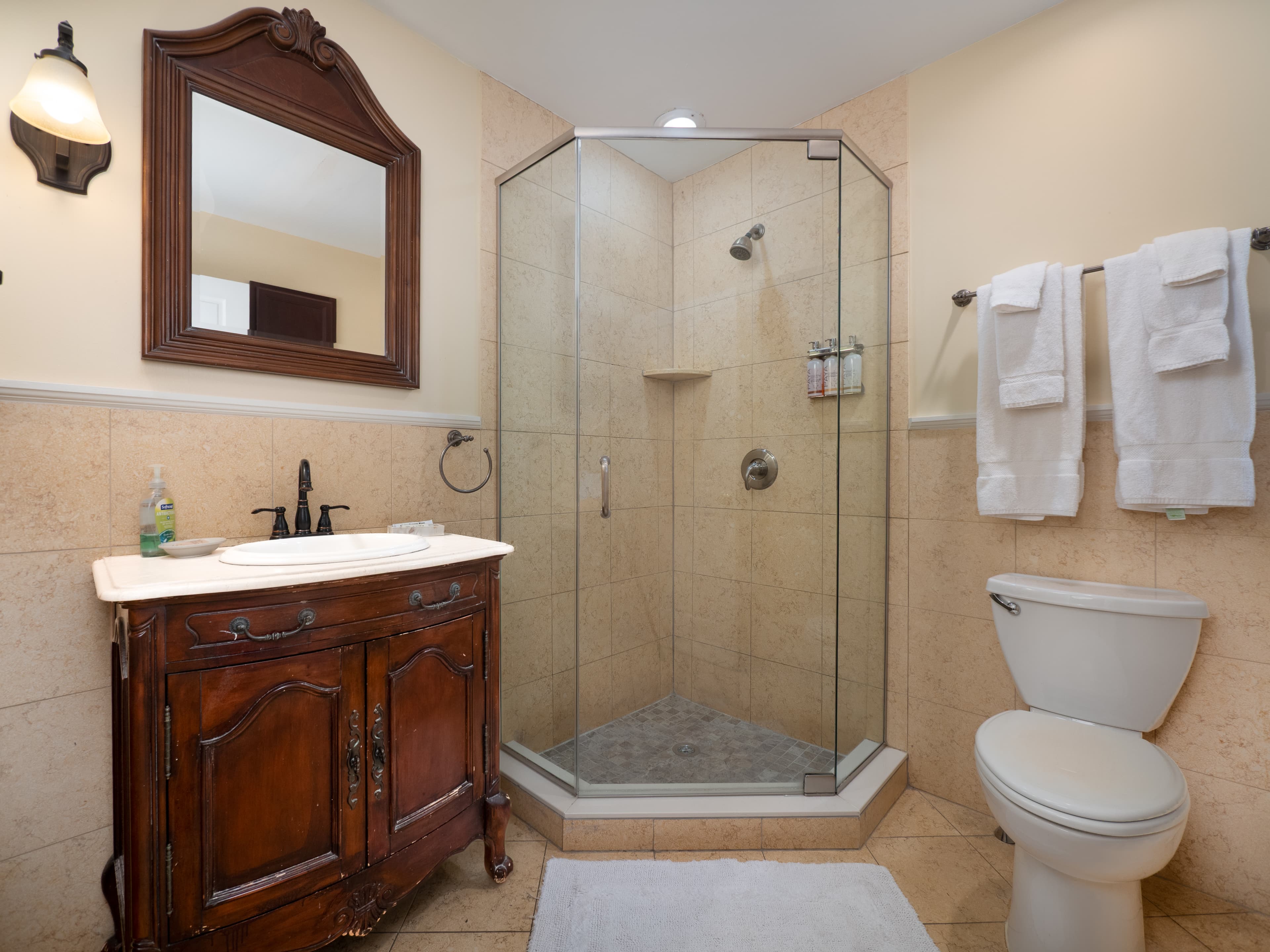 Full bathroom with glass door standing shower.